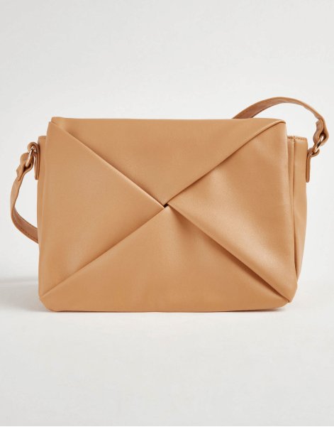 A tan fold over cross body bag