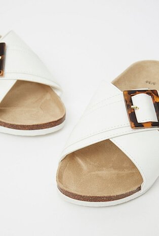 White crossover sandals with a moulded footbed and resin buckle detail