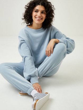 Woman wearing pale blue lounge wear set.