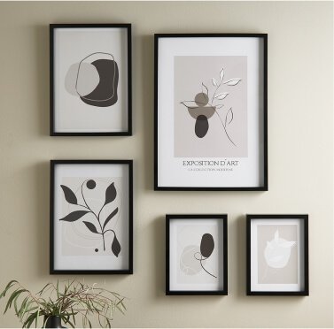 A set of black framed prints on a wall.