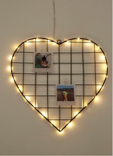 A black wire heart decor piece with lights.