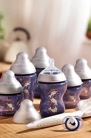 Selection of blue dolphin printed baby bottles and matching dummy.