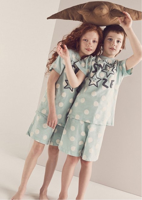 Children wearing matching slogan pyjamas.