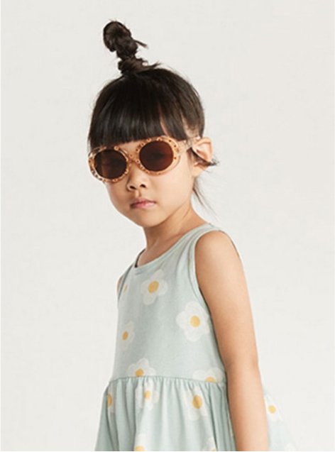 A child wearing a floral dress and sunglasses.