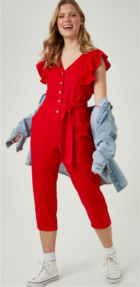 A woman wearing a red jumpsuit.