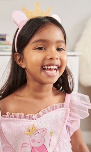 Child wearing Peppa Pig dress.