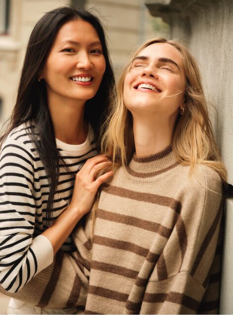 Two women wearing stripey jumpers.