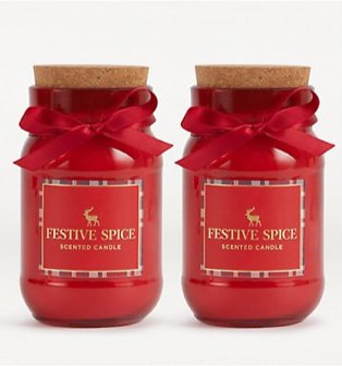 Two red festive spice cork lid candles with bow detailing.