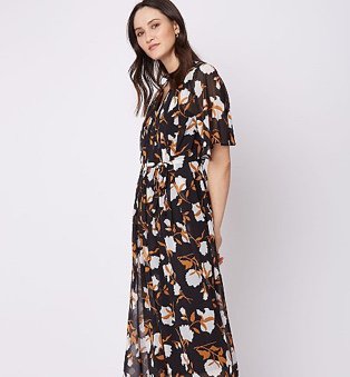 Woman in black floral pleated 2 in 1 v-neck midi dress