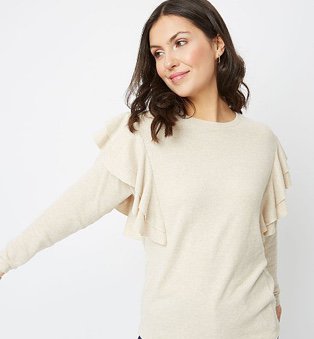 Woman in beige ruffle sleeve lightweight jumper