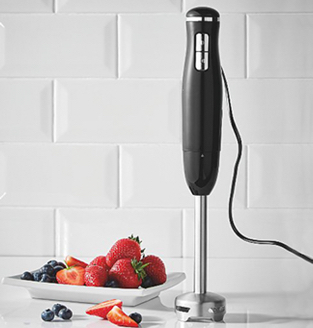 Black hand blender alongside a plate of fruit