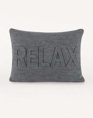 Grey cushion with relax slogan.