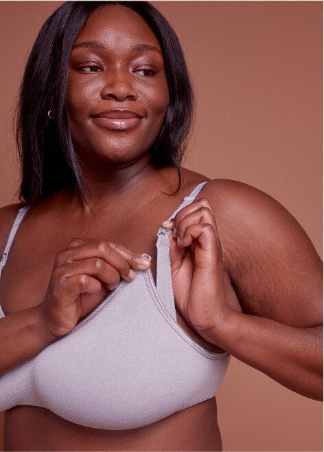 A woman wearing a grey nursing bra