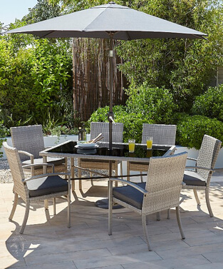 Jakarta 8 piece patio set in an outdoor area with drinks and plates on the table