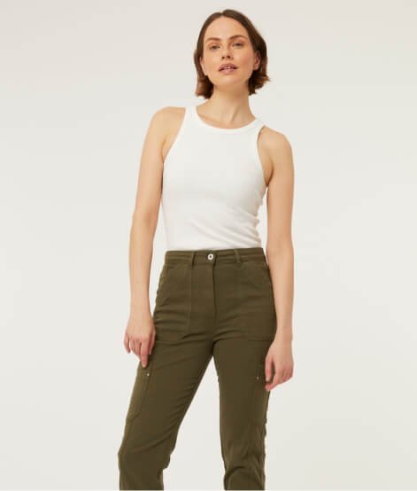 A woman wearing a white top and khaki trousers