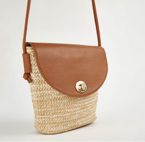 Straw cross body bag with brown flap.