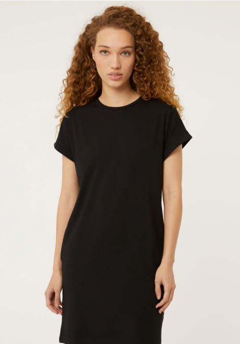 A woman wearing a black t-shirt mini dress
