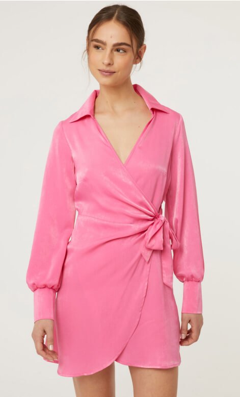 A woman wearing a pink satin wrap mini dress
