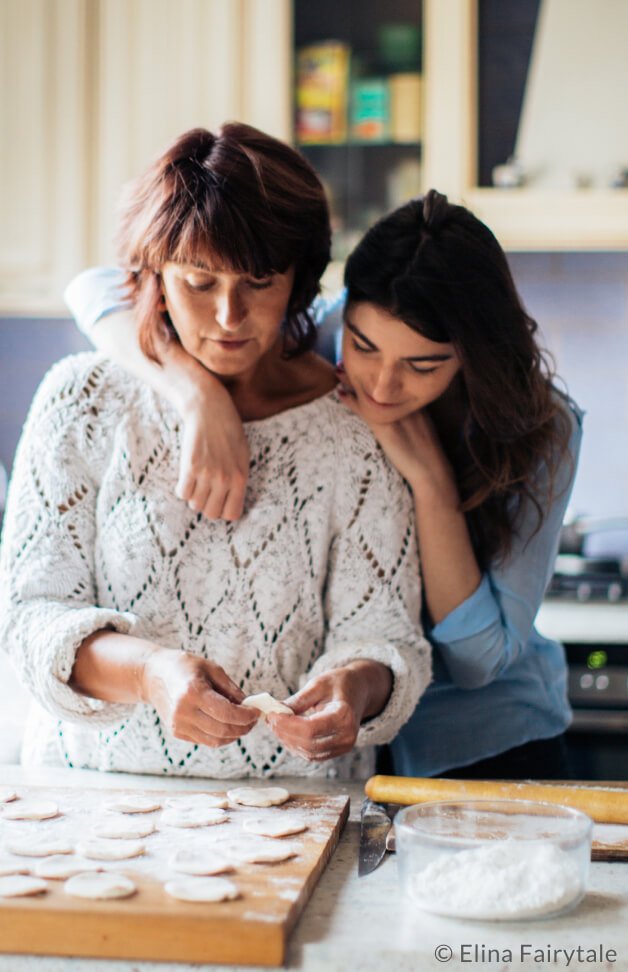 A mother and daughter baking together in a kitchen