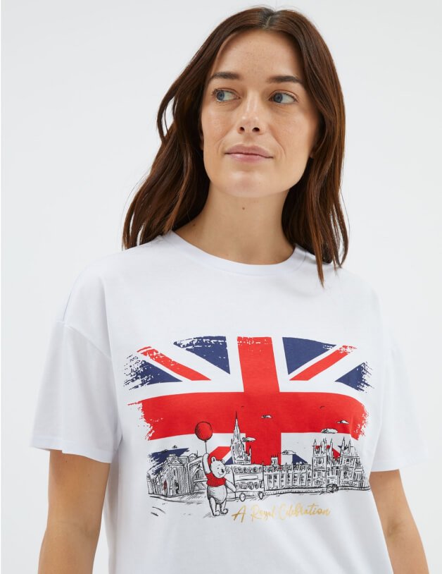 Woman poses wearing a white Union Jack t-shirt.