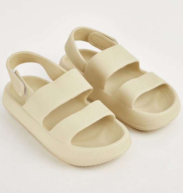 A pair of neutral strappy sandals.