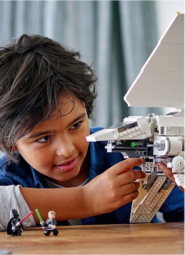 A child playing with a Star Wars LEGO set