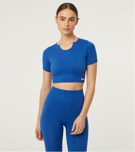 A woman wearing a co-ord blue top and leggings outfit.