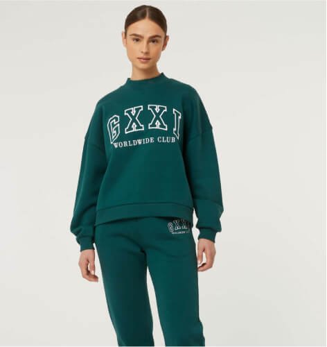 A woman wearing a green co-ord sweats set.