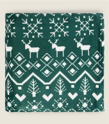 A folded green Christmas Fairisle super soft blanket