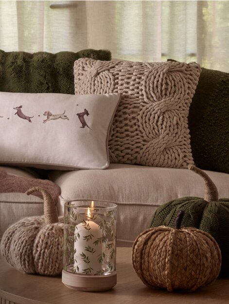 Autumnal cushions on cream sofa.