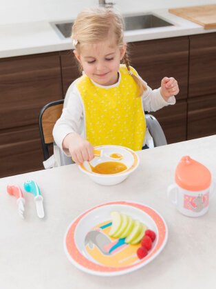 Child sitting at a table eating.