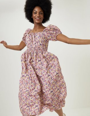 Woman wearing floral knee length dress.