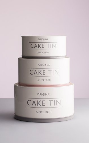 Three cake tins stacked on top of one another. 