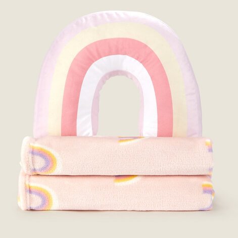 A rainbow 3D cushion on two pink rainbow fleece blankets
