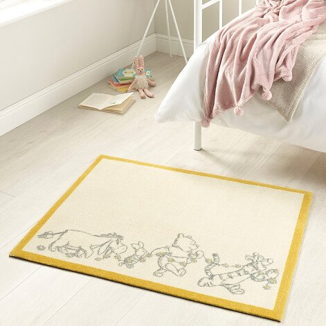 A Winnie the Pooh rug in a bedroom