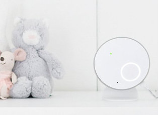 Angelcare white baby movement monitor with grey bear and pink mouse on the right