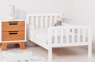 White single bed with two-tone two drawer side table and white lamp