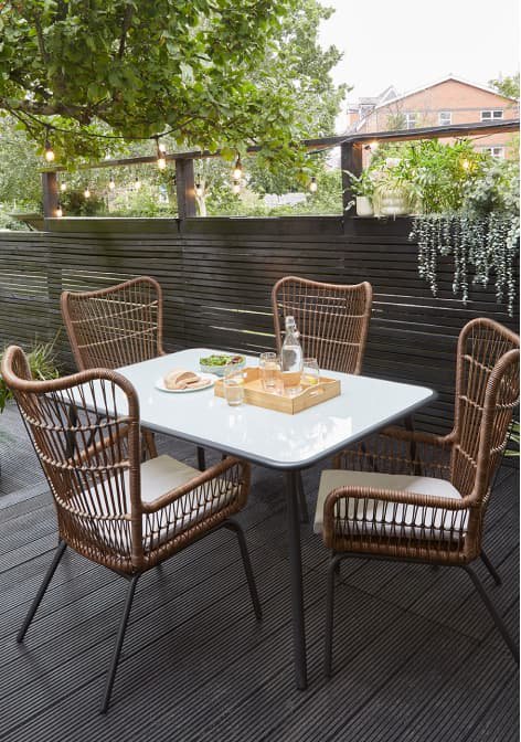 Outdoor furniture set with four chairs and a table.