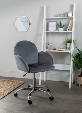 Room with grey chair and white shelving.