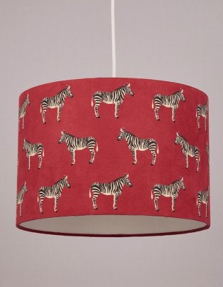 Red lamp shade with zebra print.