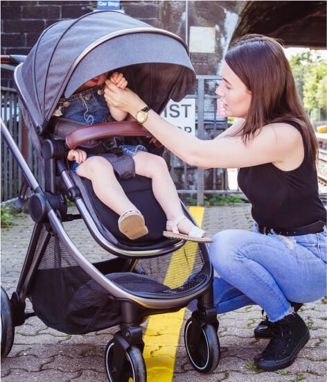 A mum with a baby in a pushchair.