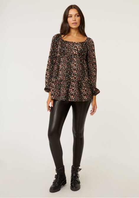 Woman wearing a leopard top with leather trousers.