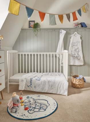 Nursery with hanging flags from ceiling, mat and toys.