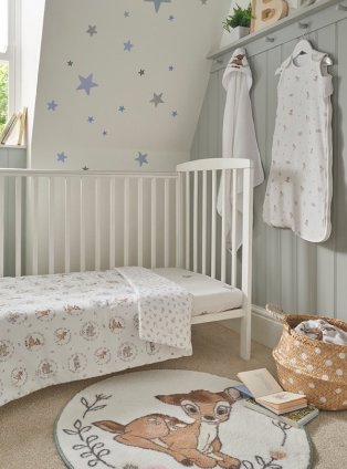 Nursery with cot and Bambi rug, toys and sleepsuit.