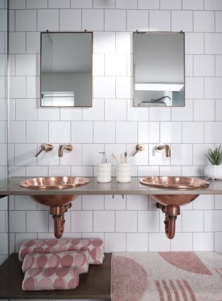 Bathroom sinks with pink towel set.