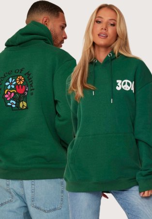 Man and woman pose wearing matching green 304 slogan hoodies and light wash jeans.